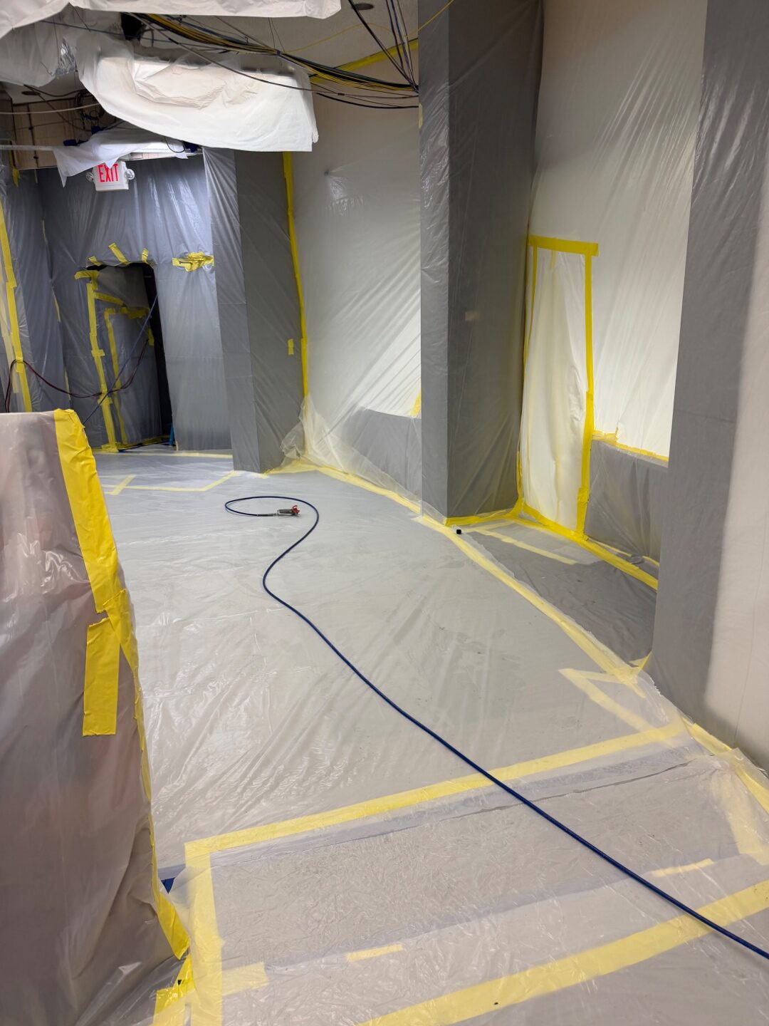 Corridor lined with poly sheeting and warning tape