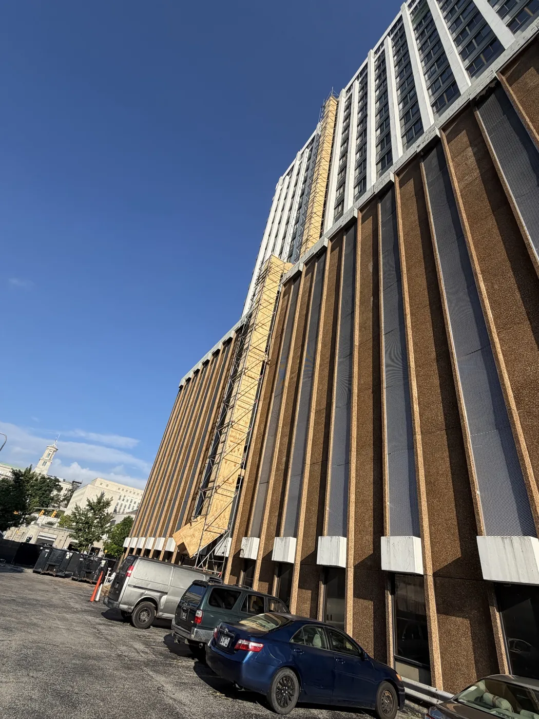 Multi-story debris chute installed on a tall building facade