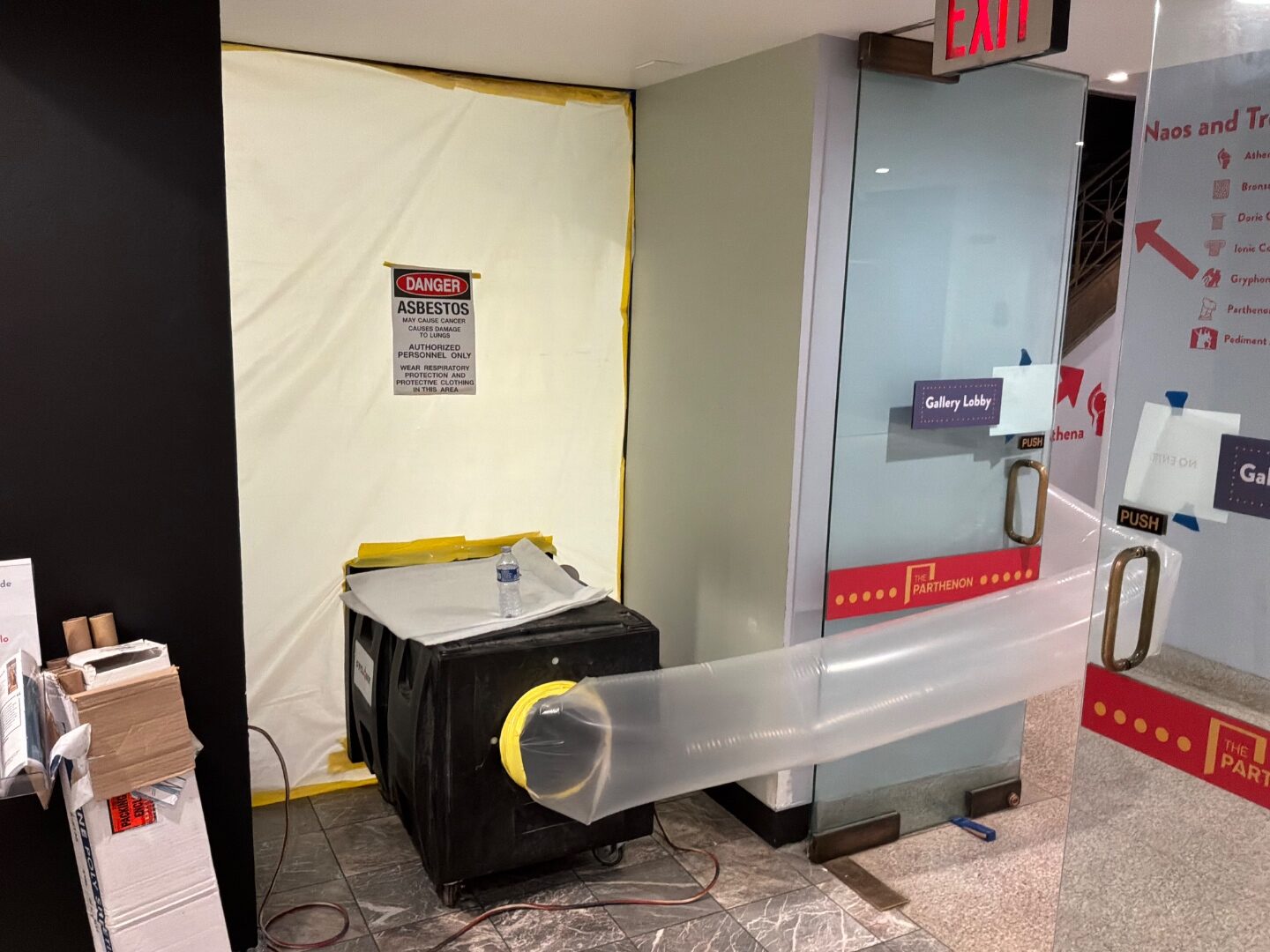 Negative air machine with exhaust duct by a sealed doorway