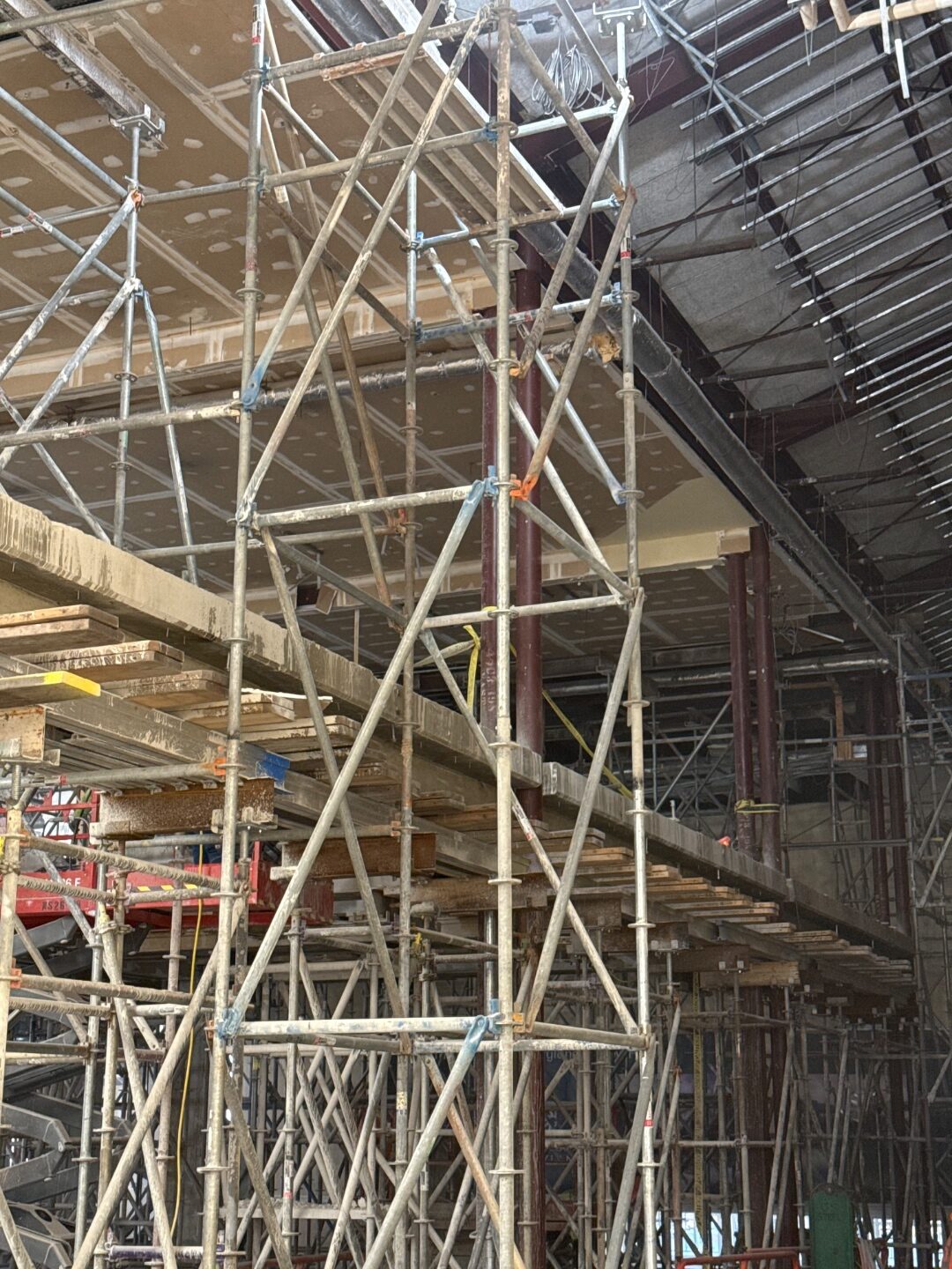Dense scaffolding rising to an exposed ceiling