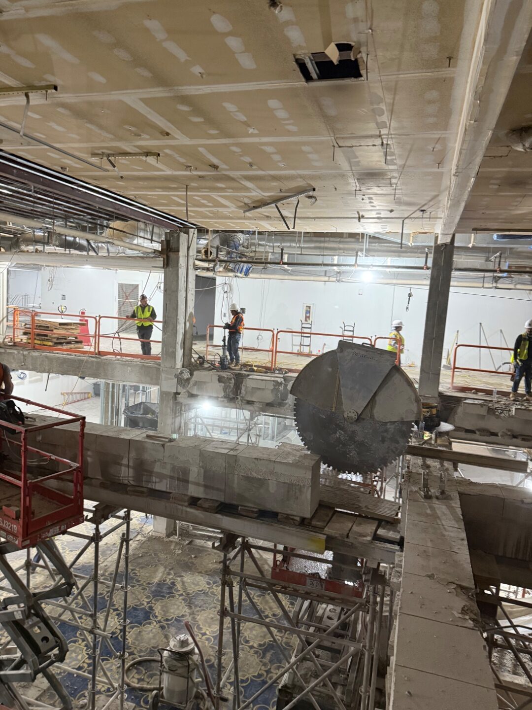 Circular concrete saw cutting through a floor slab